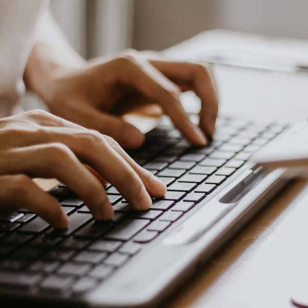 woman typing on keyboard